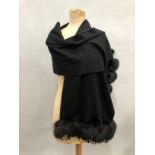 A black wool wrap trimmed with fox fur