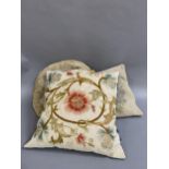 Three vintage cushions, backed in velvet, the first in crewel work on linen in vibrant colours, with