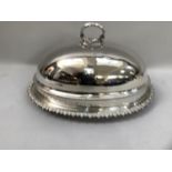 A silver plated meat cover and associated stand, the cover having a reeded loop handle and gadroon