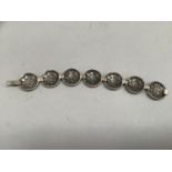 A marcasite set silver bracelet each roundel link with pierced stars, approximate length 17.5cm,