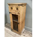 A pine livery cupboard, the two deep drawers with ring pull handles above cupboard with one internal