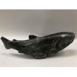 An Inuit stone carving of a salmon signed to the underside Johnassie.S, damage and repair to the