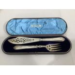 A pair of Victorian silver fish servers, the silver blades pierced and engraved with foliate