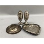 A late 19th century heart shaped silver dish chased with a rustic courting couple within a rural