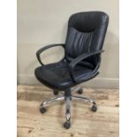 A black vinyl swivel office chair on five legs with adjustable seat and arm rest