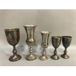 Five silver Kiddush cups, two of baluster form and three cup shaped, hallmarks for London 1921,