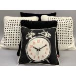 Five various cushions including two black in graduated size, a pair of white and black and a small