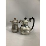 A George V silver hot water jug of circular outline, plain baluster form with box wood handle and