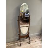 A 1920s/30s cheval mirror with bevelled glass on twin supports