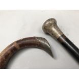 A silver collared crop with antler handle, a silver handled ebonized walking cane and a silver