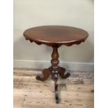 A mahogany ovaL tripod window table