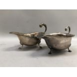 A George V silver sauce boat, with incised rim, 'C' scroll handle and scalloped pad feet, hallmarked