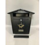 Black metal letterbox with key for wall mounting