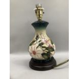 A Moorcroft table lamp of baluster outline, tube lined and glazed in ivory, pale yellow, pink and
