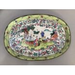 Chinese enamelled metal tray of oval outline, painted with figures in a garden landscape within a