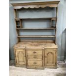 A Victorian pine dresser with moulded cornice above three tier plate rack with cup hooks, the