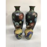 Pair of Cloisonne vases on black ground with another yellow pair, pair of copper pitchers, ornate