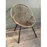 A cane 1970s chair on metal framing, cane bucket seat