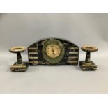 An Art Deco marble and onyx clock garniture, the clock of curved outline, the dial with Arabic