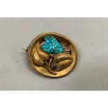 A Victorian turquoise broch in 15ct gold, of oval outline applied to the centre with a trifoil of