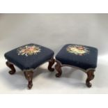 A pair of stools on carved cabriole legs with needlework upholstery