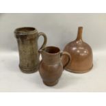 A salt glaze funnel, a salt glaze jug with reeded handle and a stoneware tankard by A G Hopkin