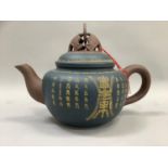 Large Yixing clay teapot the blue body bearing incised calligraphic script, with moulded medallion