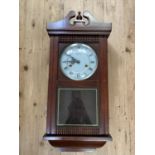 A reproduction wall clock in mahogany stained case, the enamel dial with black Roman numerals