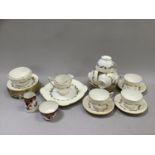 Minton gold laurentian tea set comprising eight cups and saucers, eight side plates, cake plate,