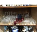 A quantity of glassware featuring cut glass wines, trifle dishes, mid century dessert bowls, port