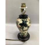 A Moorcroft table lamp of baluster form, tube lined and glazed in ivory coral and shades of green