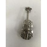 A silver snuff box in the form of a cello with foliate scroll chasing, approximate length 9cm,