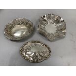 A silver pin tray embossed with iris together with two silver pierced bon bon dishes c.1900