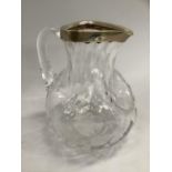 A silver rimmed glass water jug of triple dimpled form, smoothed pontil, 19cm high, Birmingham 1885,