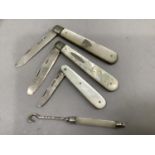 Three mother of pearl and silver fruit knives together with mother of pearl and silver button hook ,