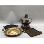 Korean sinseollo stainless steel lidded pan with ceramic ring handles atop burner together with twin