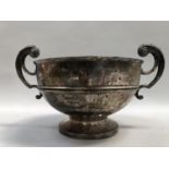 An Edward VII silver trophy, banded shallow bowl form, with scroll handles over a circular foot,