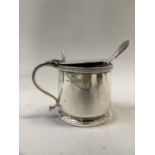 A George V silver mustard pot of drum form with disc cover, egg and dart rim, shell thumb piece