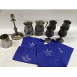 A set of four modern pewter goblets, a pair of tankards with initials, a taper stick etc