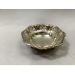 A George V silver bon bon dish, pierced and scrolled rim within a circular outline, Hallmarks