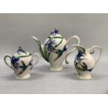 A Franz porcelain three piece tea service moulded in relief with iris and hummingbird, comprising