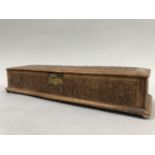 An Art Nouveau leather covered glove box the top and side panels embossed with scrolling iris, the