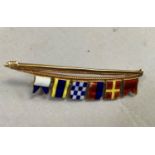 A yachting brooch in 9ct gold and enamel (at fault) showing a hoist of nautical signal flags