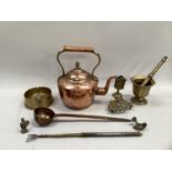 A copper kettle, brass pestle and mortar, shell case dish, trivet, vesta case, copper ladle,
