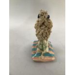 A Basil Matthews ceramic figure of Simone, a French poodle sat upon a striped cushion, signed titled