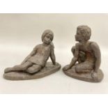 Two bronze effect resin figures of a young girl reclining and a young boy crouched on one knee, 15cm