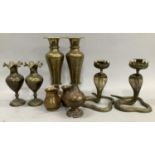 A pair of brass candlesticks in the form of cobras, together with pair of Beneres vases on stepped