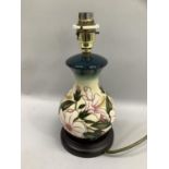 A Moorcroft table lamp of baluster outline, tube lined and glazed in ivory, pale yellow, pink and