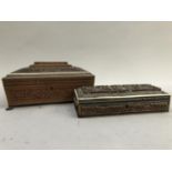A middle eastern box, the top with carved foliage and buildings, inlaid with bone, on paw feet,