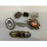 Six late 19th century and early 20th century brooches all in gilt base metal or rolled hold mounts